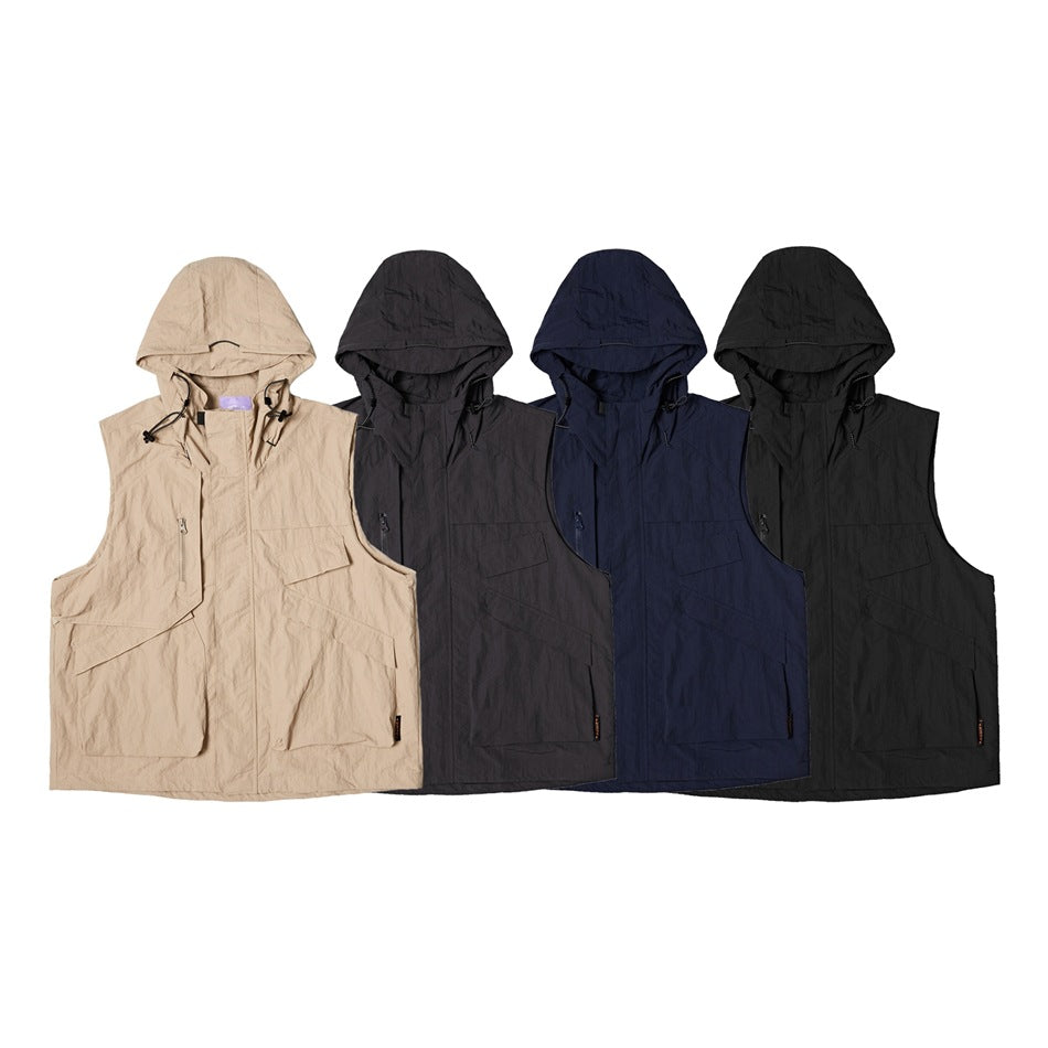 Four sleeveless hooded vests with front pockets shown in beige, charcoal, navy, and black.