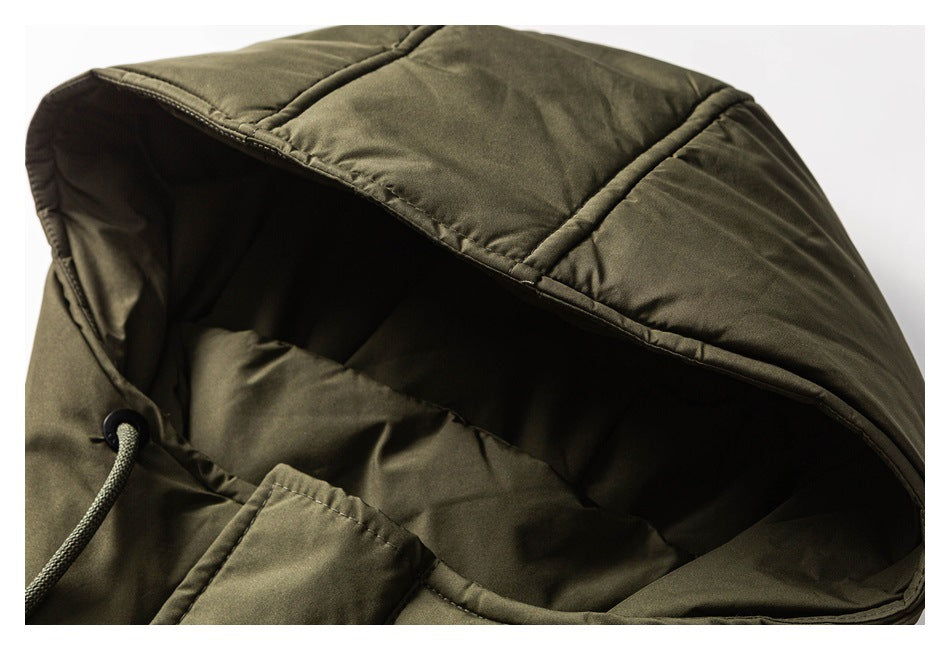 Close-up of an olive padded jacket hood with stitched panels and a drawcord.
