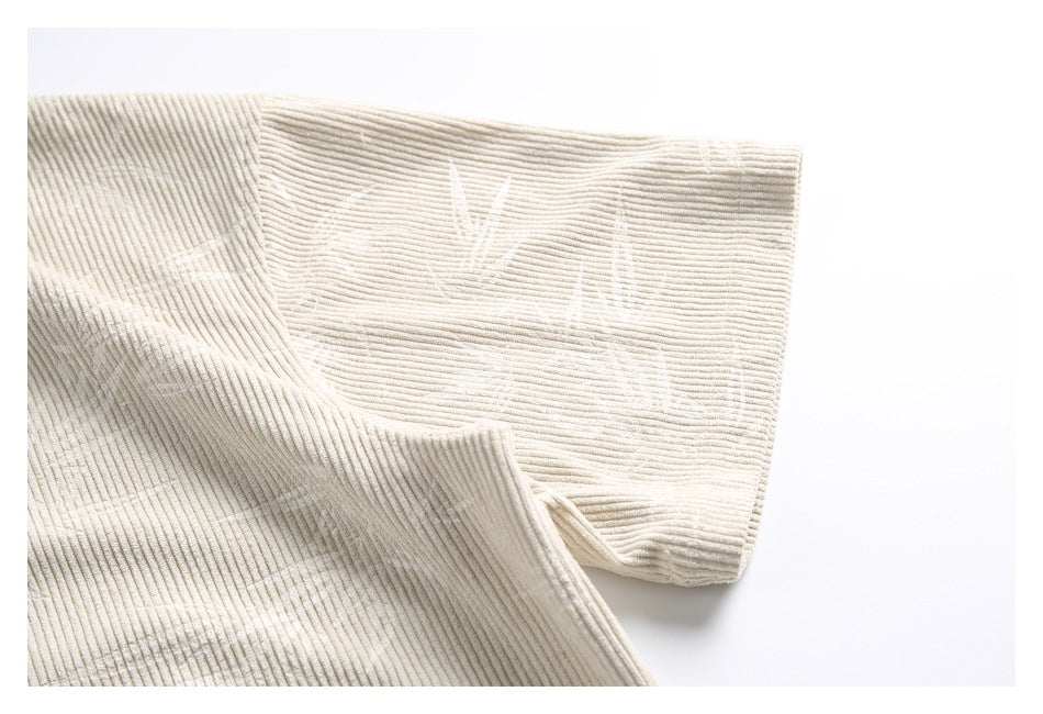 Close-up of the cream tunic's short sleeve and ribbed fabric texture.