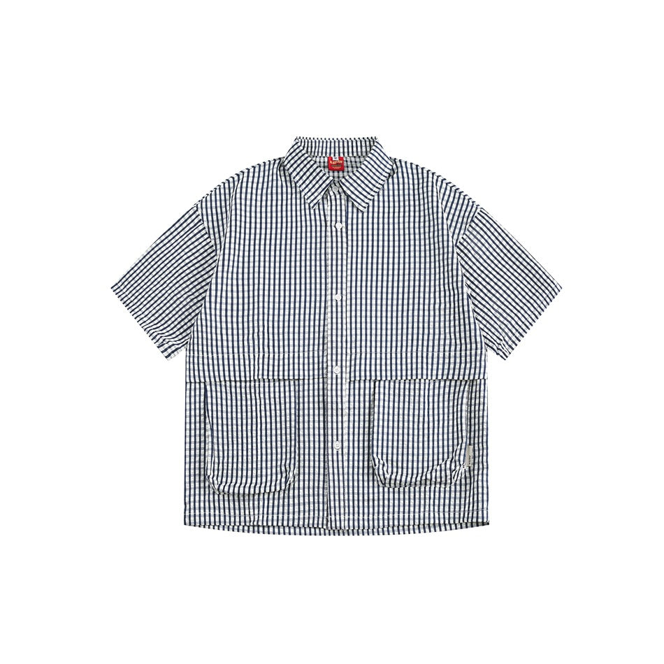 Navy blue and white gingham short-sleeve button-up shirt with two large front flap pockets, flat lay front view