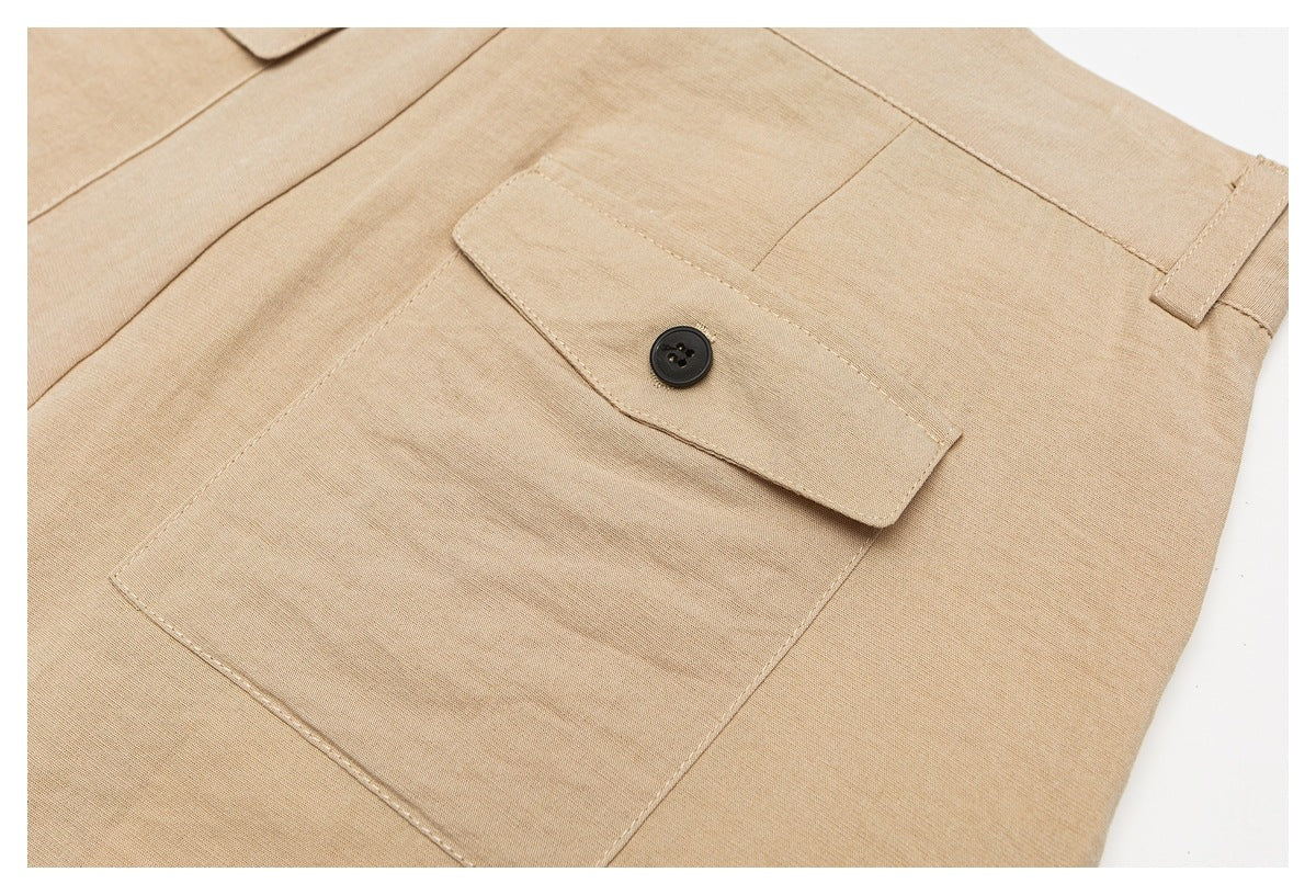 Close-up of a large button-flap pocket on tan trousers.
