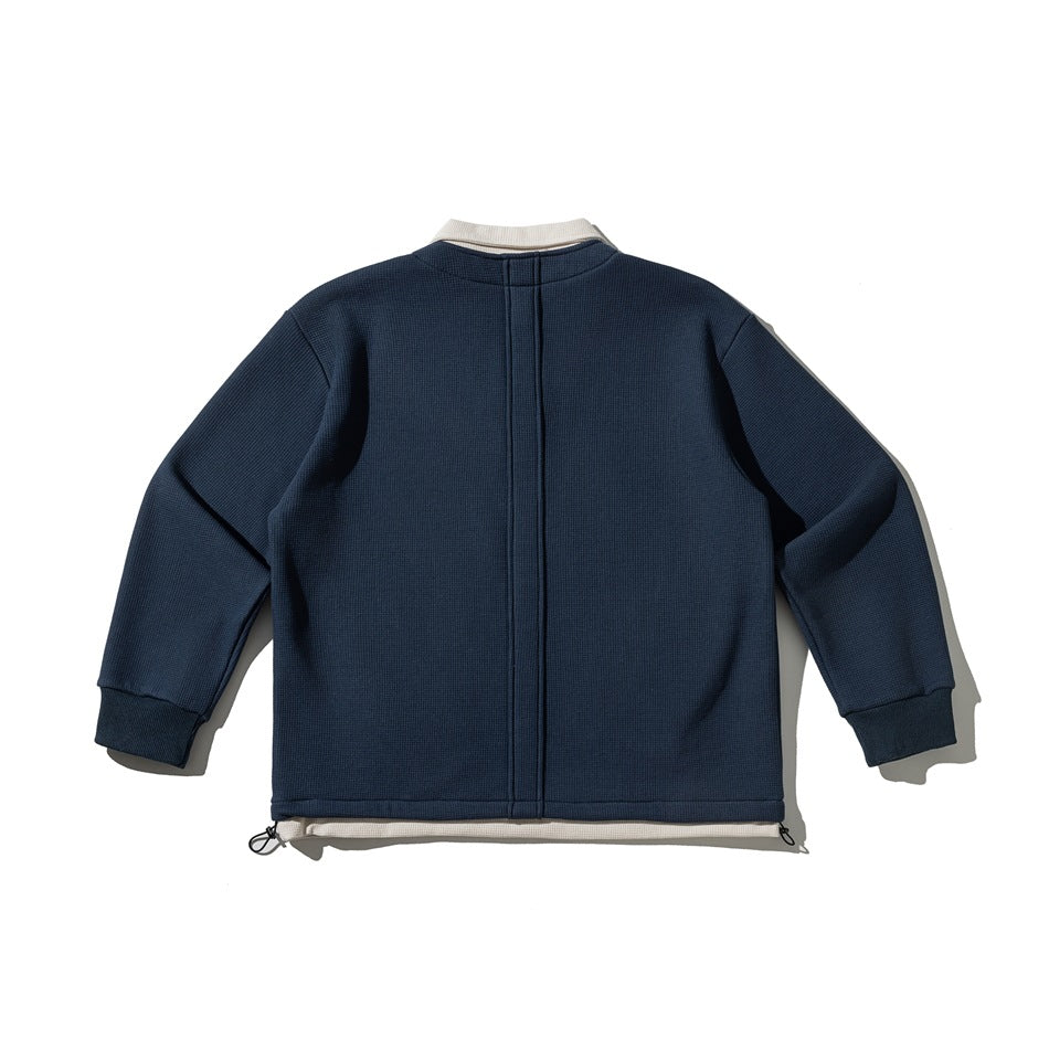 Back view of a navy pullover with a cream collar and hem accent, center seam, ribbed cuffs and hem drawcords.