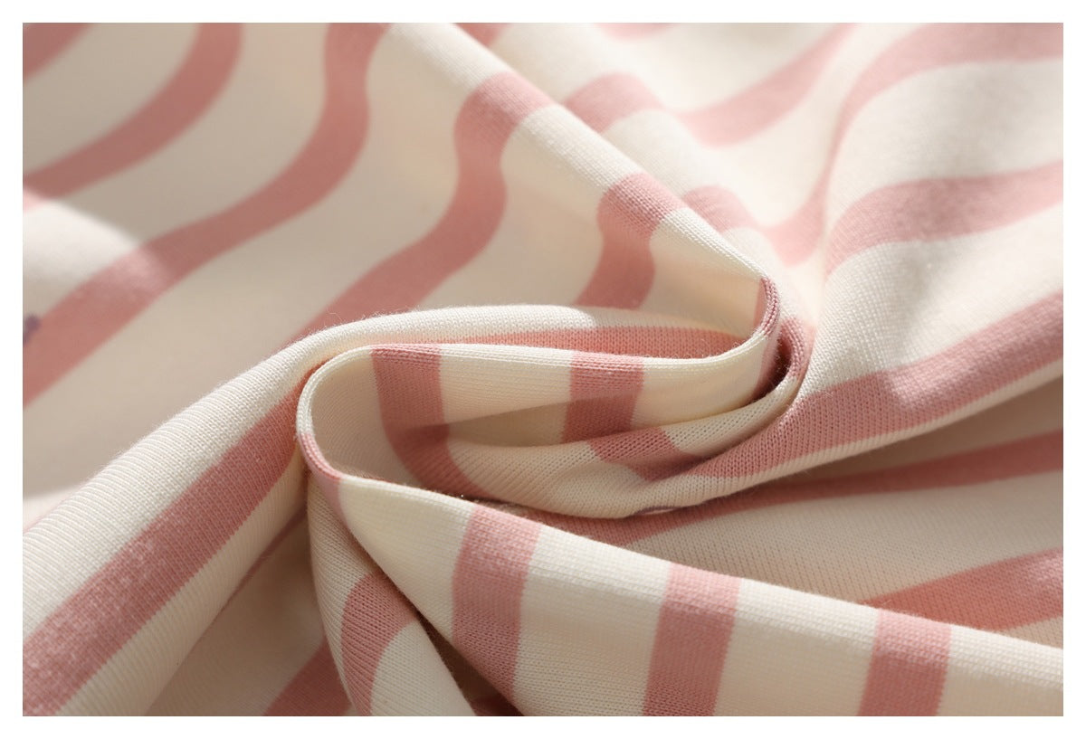 Close-up of pink and cream striped fabric draped into soft folds.