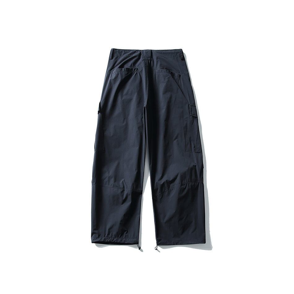 Back view of navy wide-leg cargo pants showing back pockets, side cargo pockets and knee seams