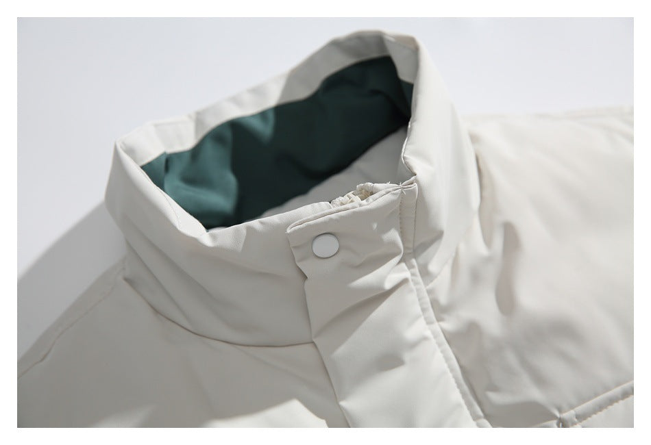 Close-up of the vest's high collar, dark green lining, and snap-button neck tab.