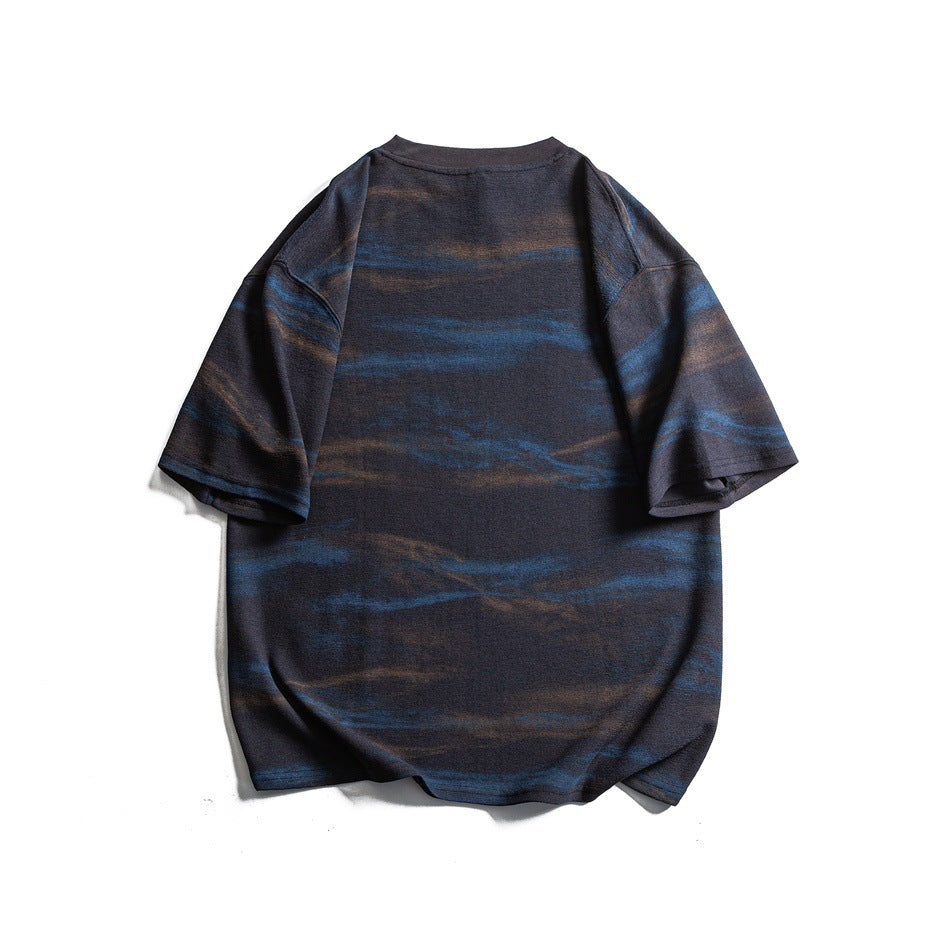 Back view of a navy oversized T-shirt with irregular blue and brown horizontal stripes.