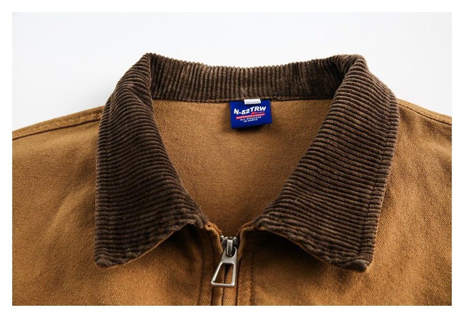 Upper front of a tan jacket with a wide brown corduroy collar, central zipper and sewn-in neck label.