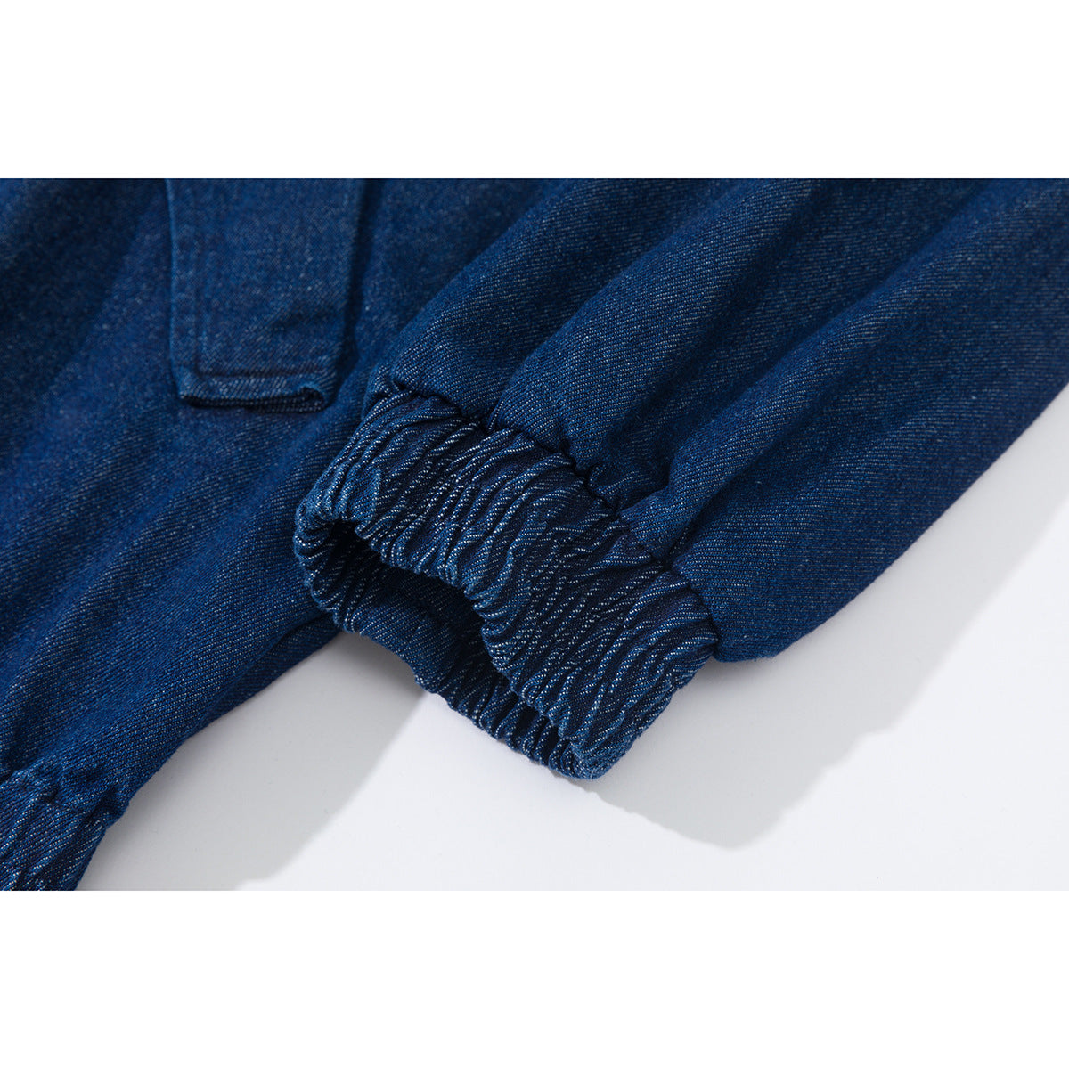 Close-up of a dark blue jacket sleeve with a gathered elastic cuff.