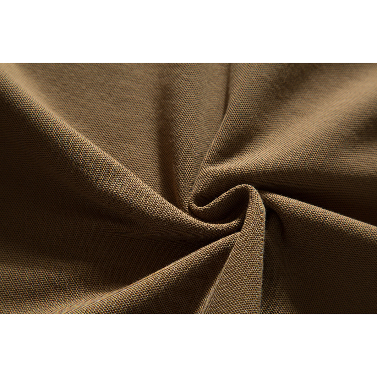 Close-up of tan-brown polo fabric gathered into folds, showing its textured surface.