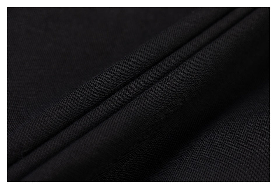 Close-up of black fabric folds showing a fine ribbed texture.