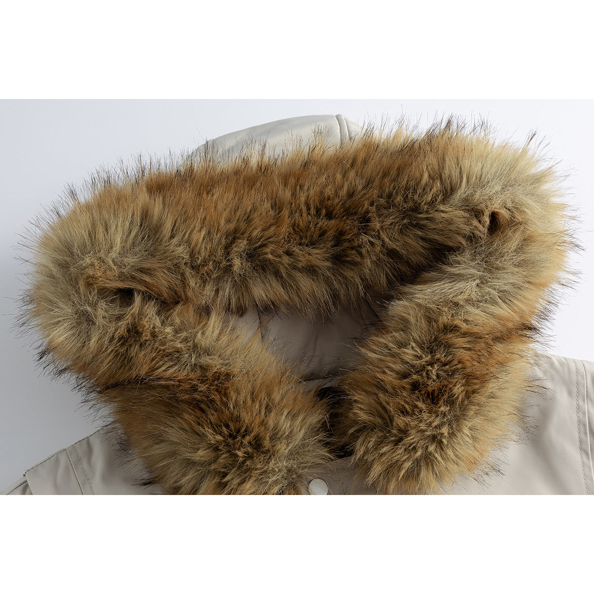 Close-up of a thick brown and tan fur-trimmed hood on a light gray jacket.
