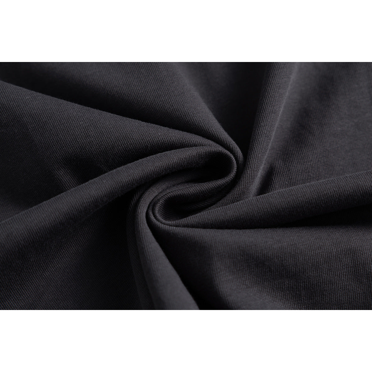 Close-up of dark charcoal fabric gathered into folds, showing its knit texture.