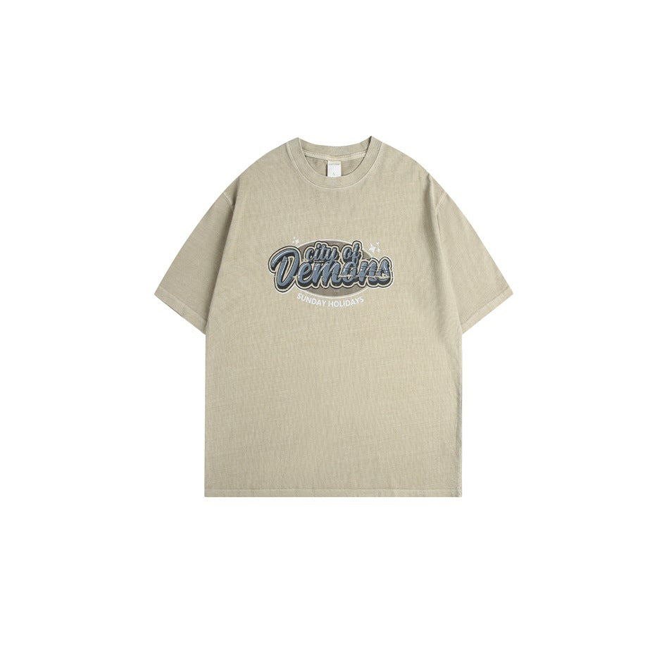 Khaki short-sleeve crew neck T-shirt with 'city of Demons' blue chest graphic, flat lay front view