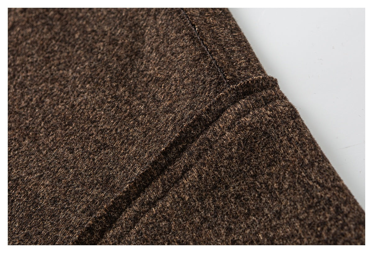 Close-up of a dark brown jacket seam and folded fabric edge.