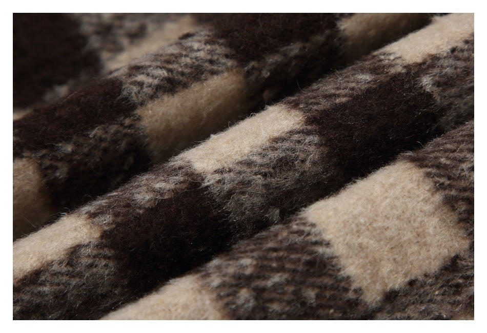 Close-up of the fuzzy brown, beige, and gray plaid fabric texture.