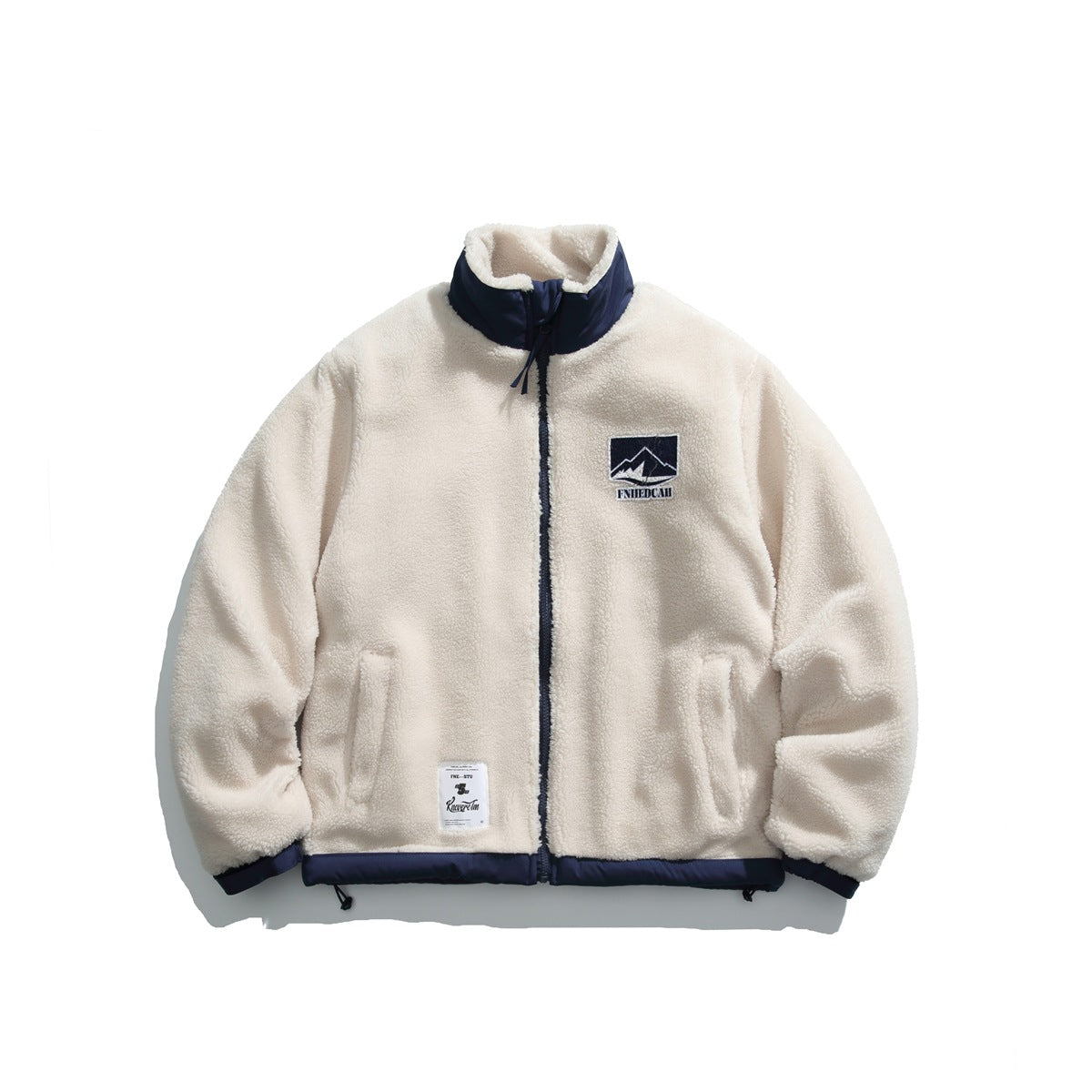 Beige sherpa-style fleece zip jacket with navy collar, trim and mountain patch, front flat view