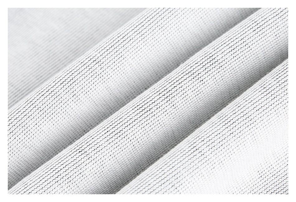 Macro view of light gray textured fabric draped in soft folds.