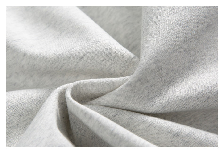 Close-up showing the light heather-gray sweatshirt fabric draped in soft folds.