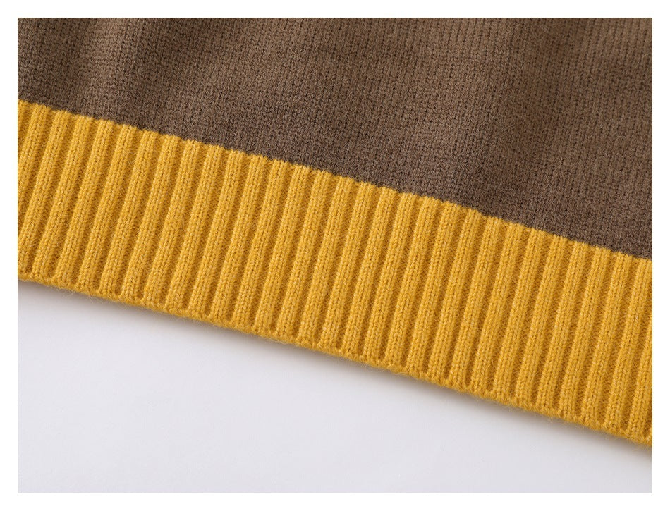 Close-up of a brown sweater's mustard yellow ribbed hem and knit fabric.