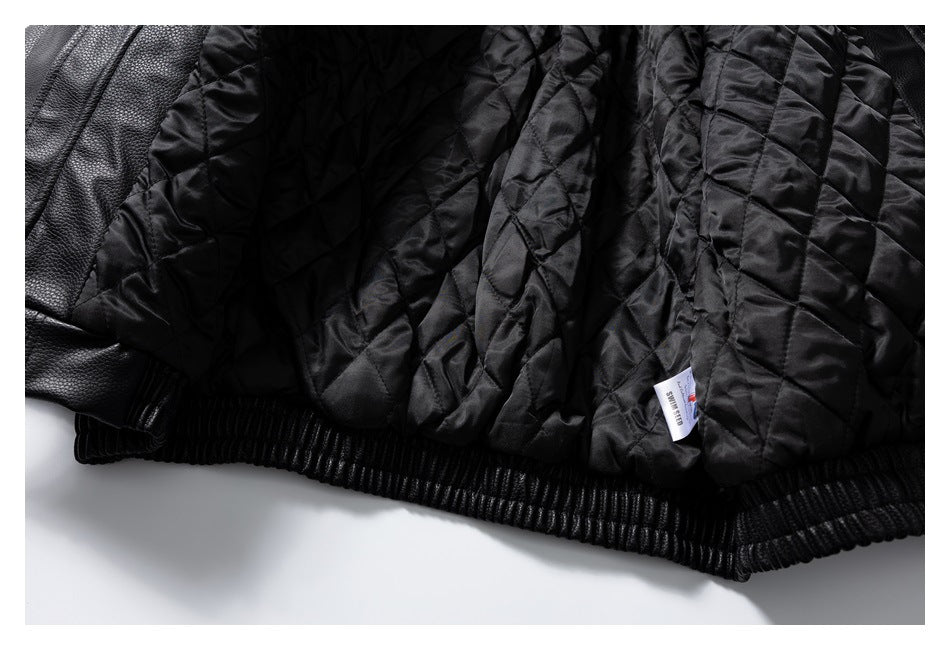 Close-up of a black jacket's quilted lining, ribbed hem, and small sewn-in label.