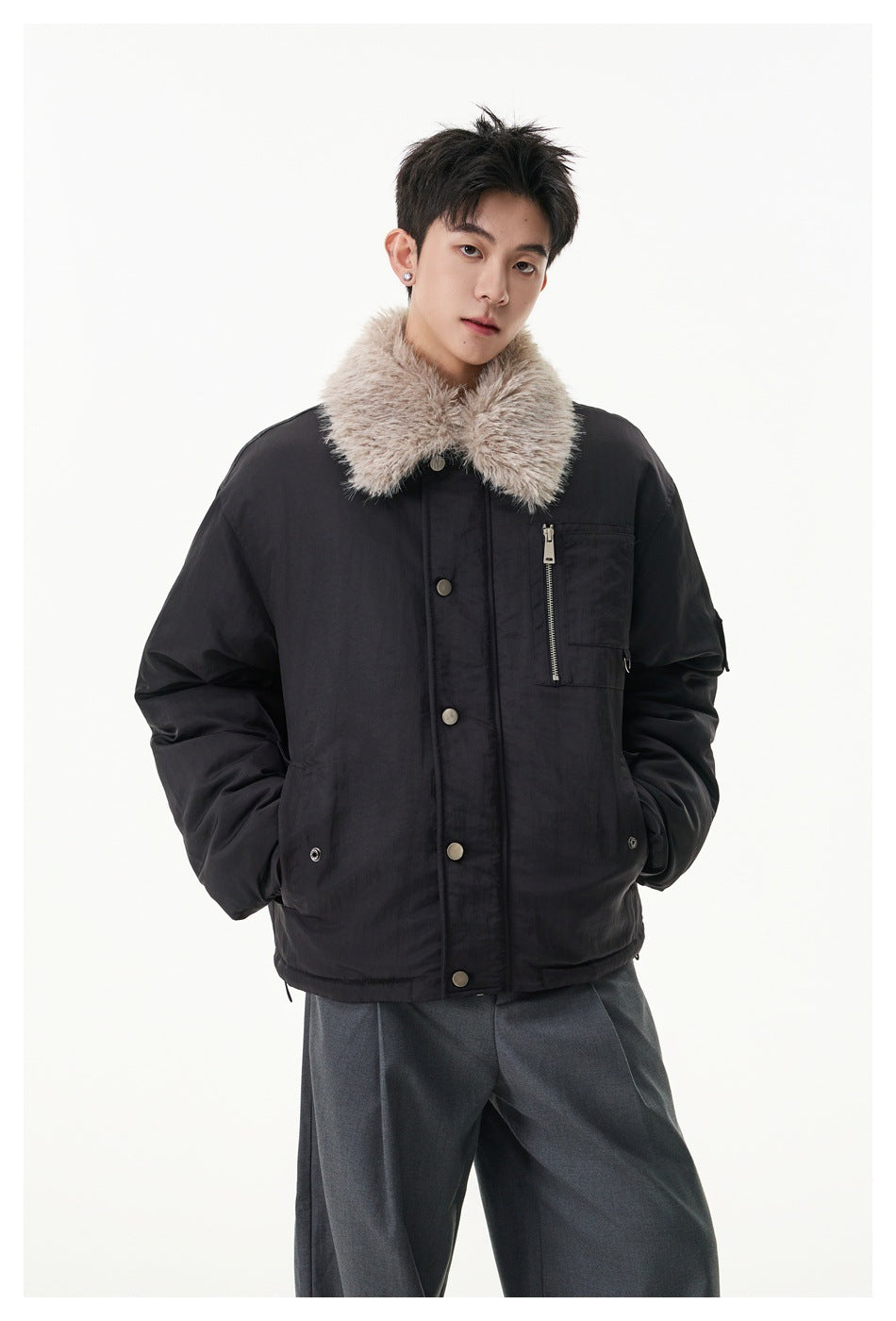 Model wearing a black jacket with a plush light collar, snap front, and zippered chest pocket.