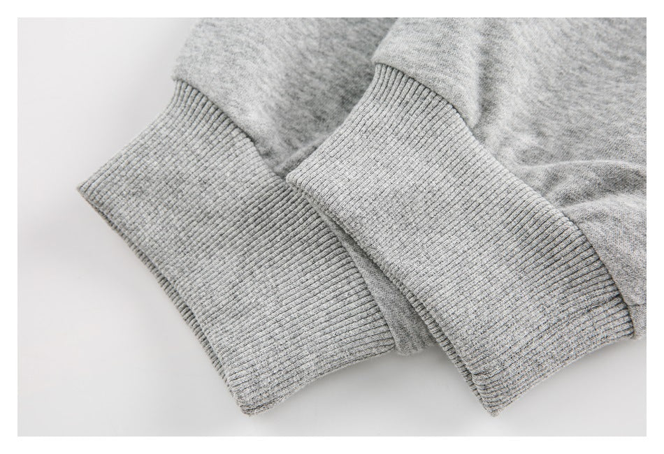 Close-up of two ribbed cuffs on a light gray heathered garment.