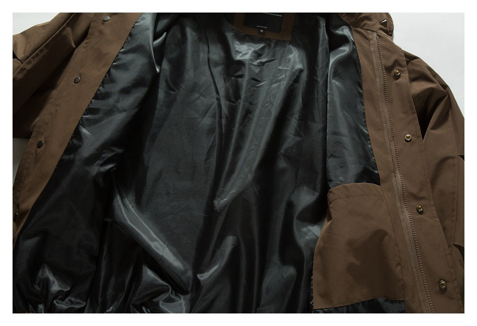 Brown jacket laid open to show its dark lining, snap buttons, zipper, and interior pocket.