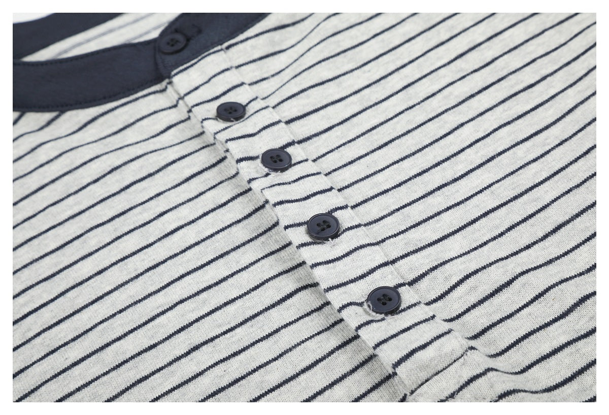 Close-up of the striped shirt's dark button placket and collar trim.