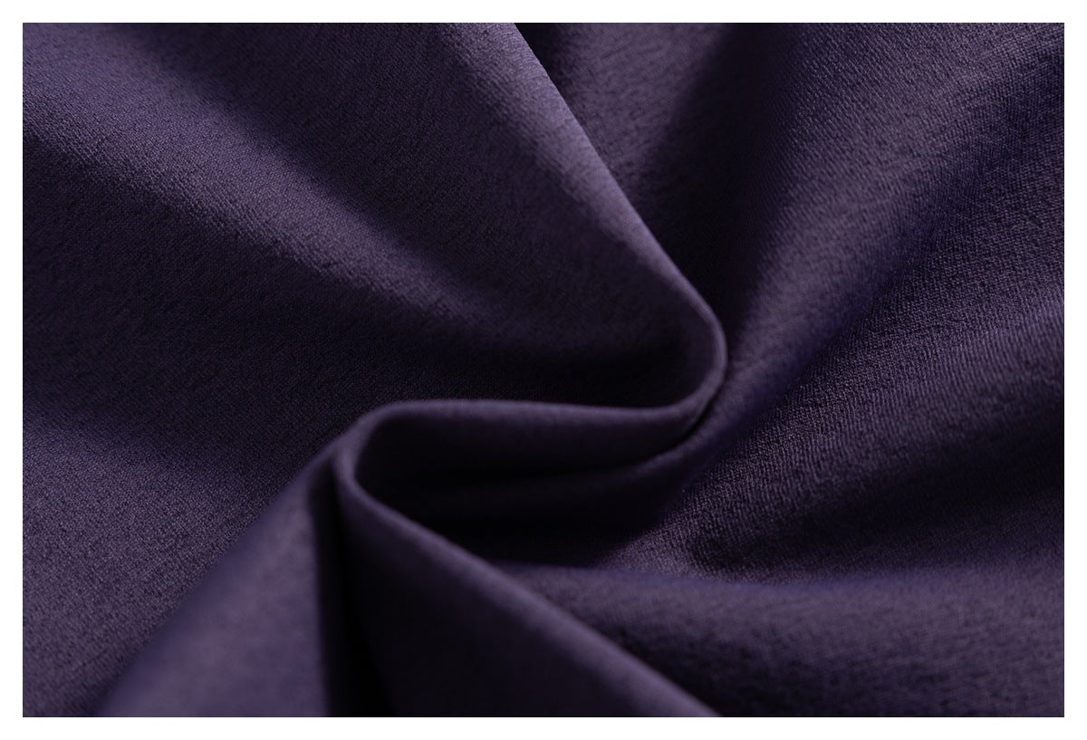 Close-up of softly folded dark purple fabric showing its surface texture.