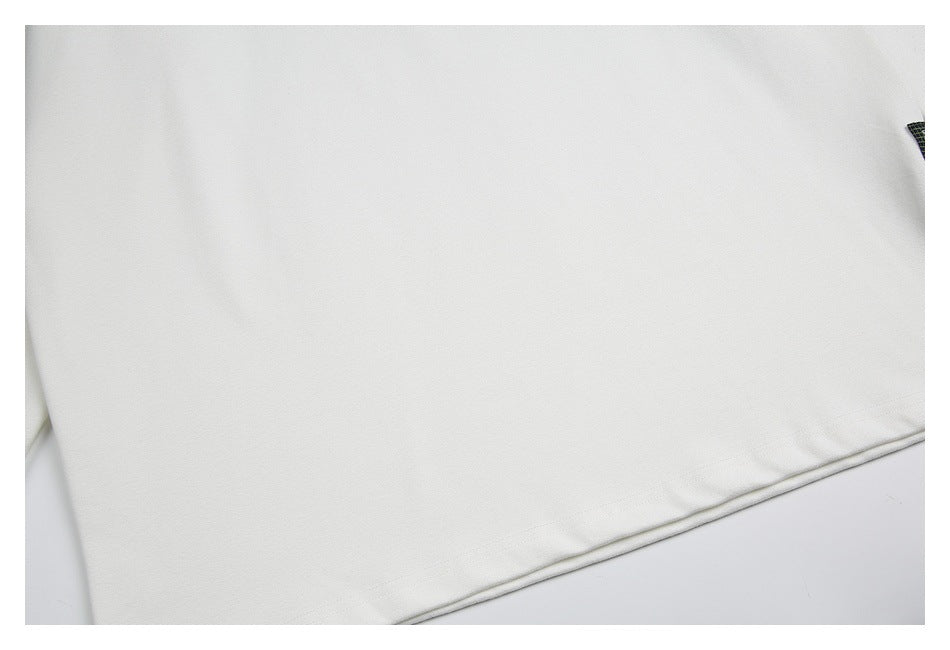 Close-up of the hem and stitching on a white garment.