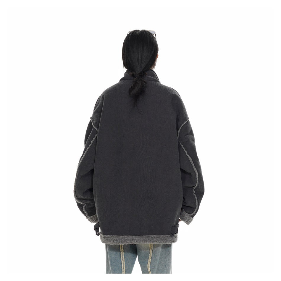 Back view of a model wearing an oversized charcoal jacket with contrast seam details and gray trim.