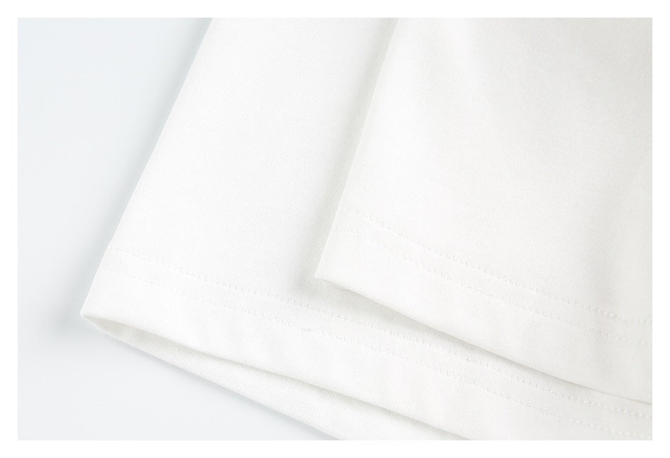 Close-up of a white garment hem with parallel rows of stitching.