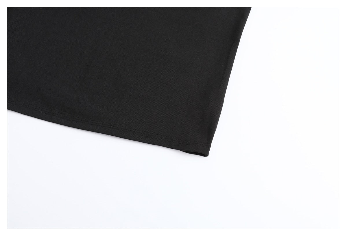 Close-up of the plain black T-shirt body and stitched bottom hem.