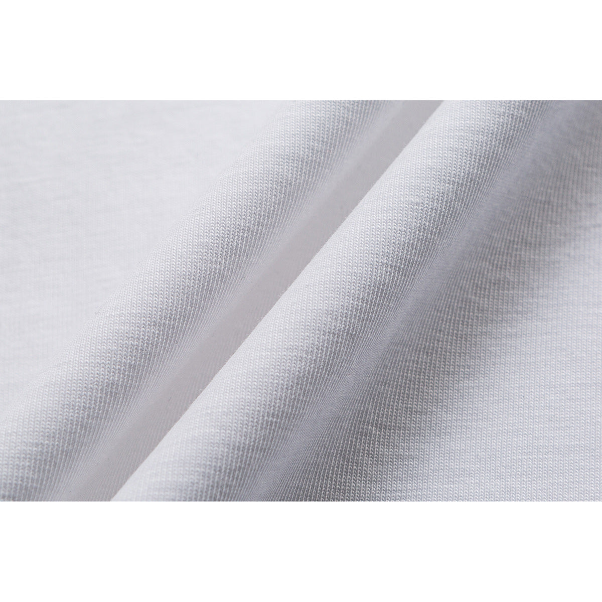 Close-up of the knit texture of white T-shirt fabric.