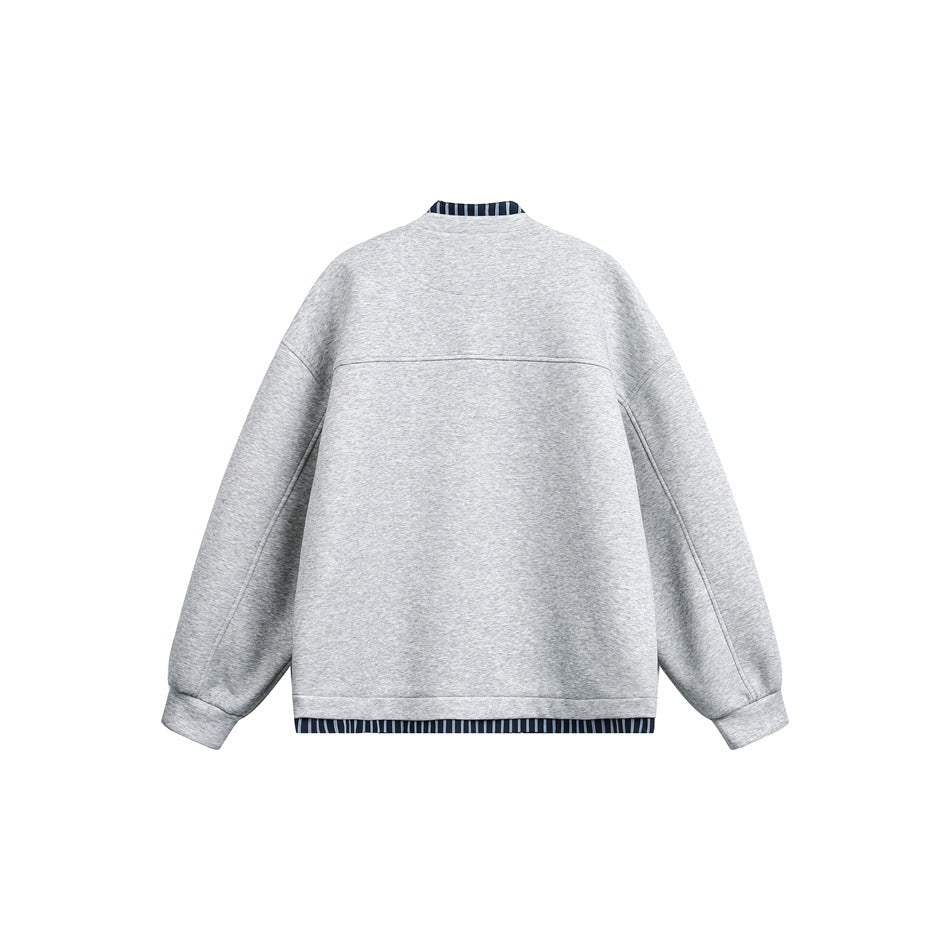 Back view of a light gray jacket with dropped shoulders, roomy sleeves, and striped trim at the collar and hem.