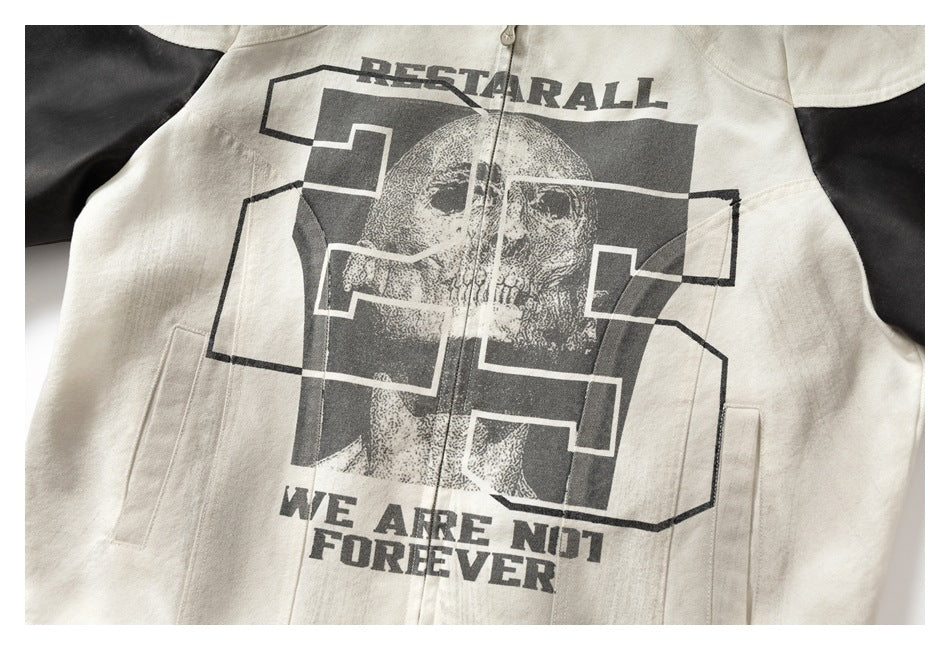 Close-up of an off-white jacket front with black sleeves, a skull graphic, geometric lettering, and the printed words “WE ARE