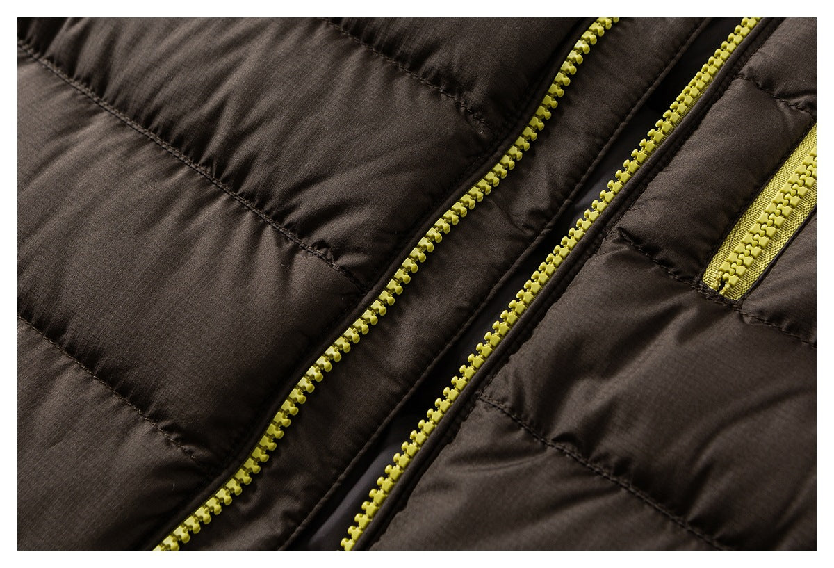 Close-up of a dark brown padded jacket showing its bright yellow front zipper and pocket zipper.