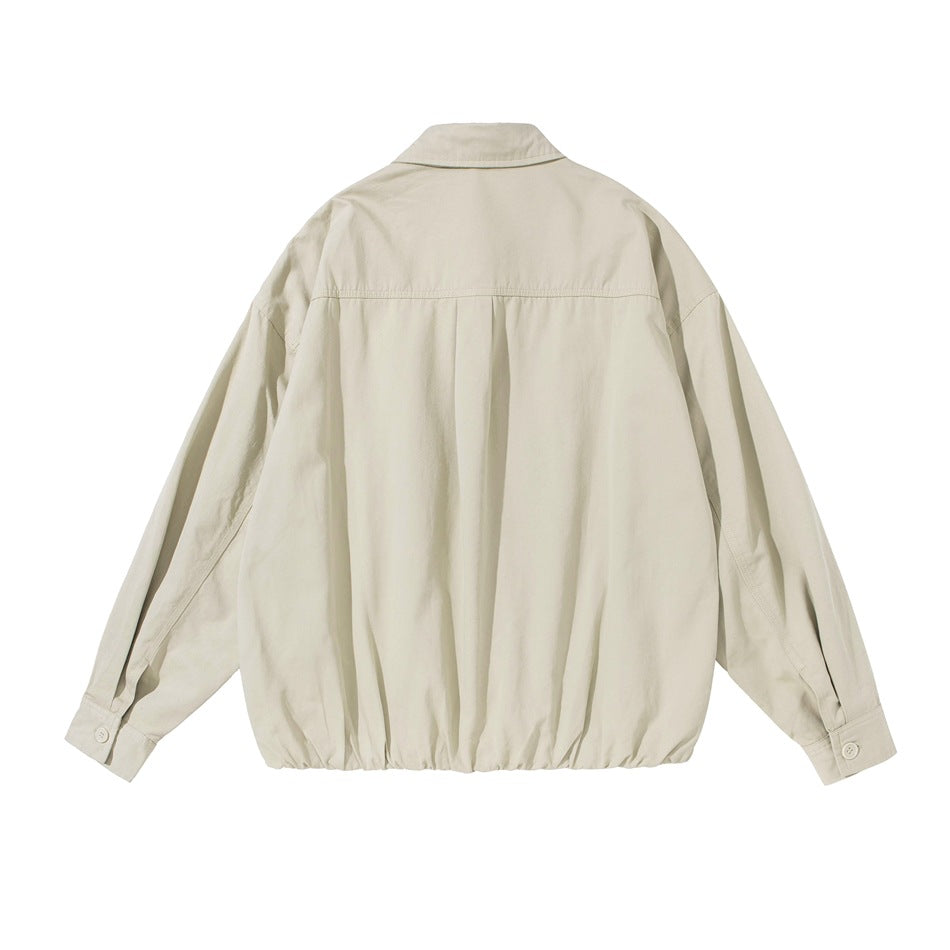 Back view of a light beige collared jacket with a gathered hem and long sleeves.