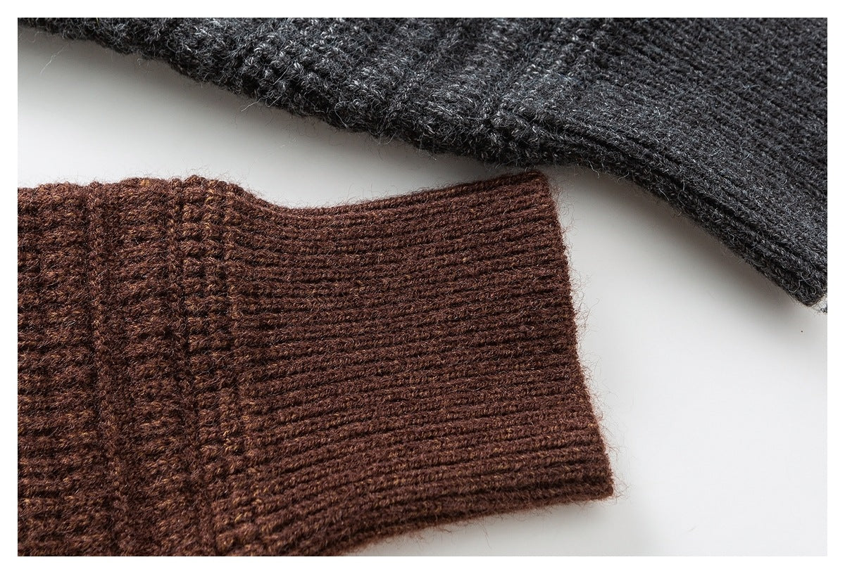 Close-up of brown and charcoal knit sleeve cuffs showing ribbed edges and textured stitching.
