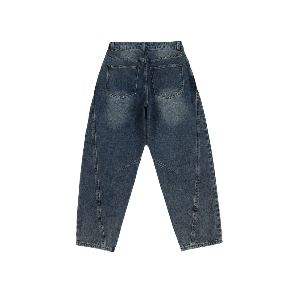 Back view of blue-gray washed denim jeans with two patch pockets, faded seat and curved leg seams