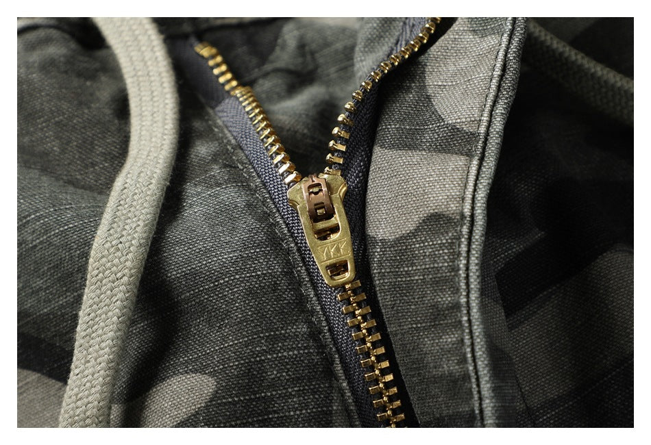 Close-up of the camouflage pants’ brass-colored zipper and drawcord.