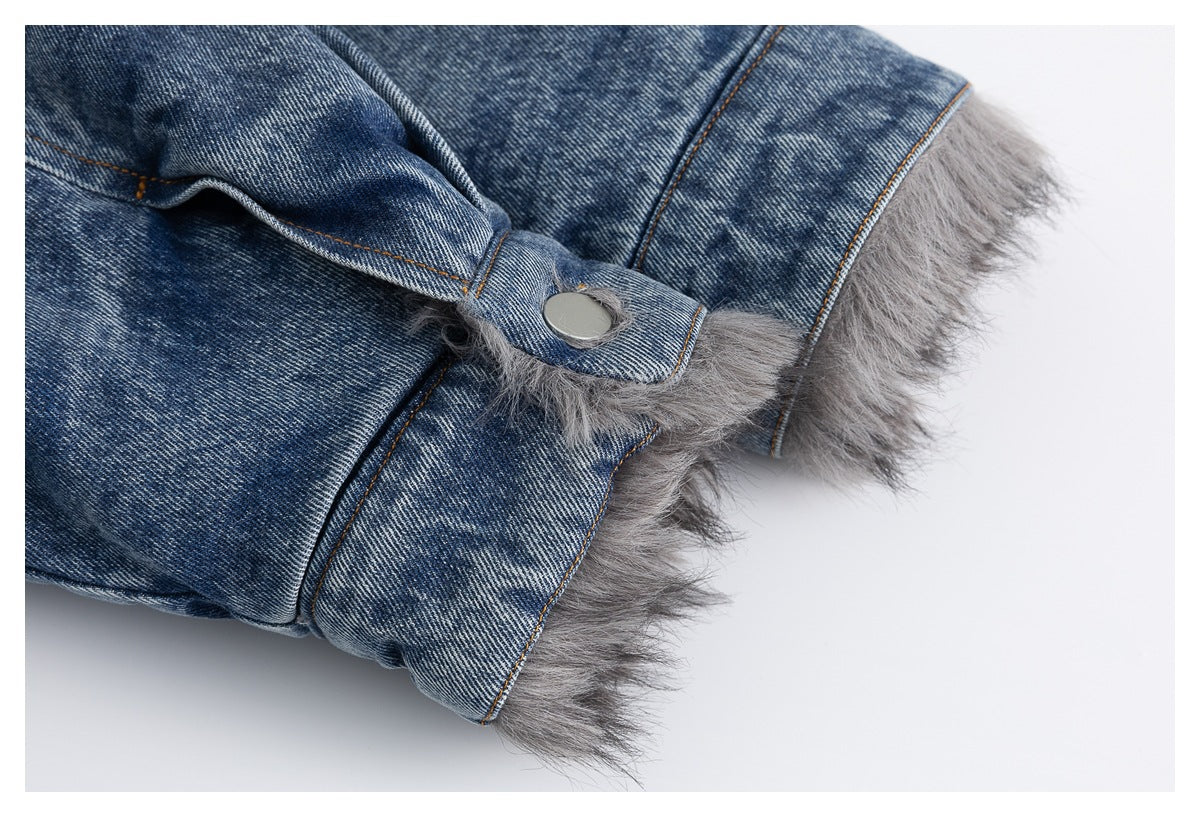 Close-up of a blue denim jacket cuff with a silver snap and gray faux-fur trim.