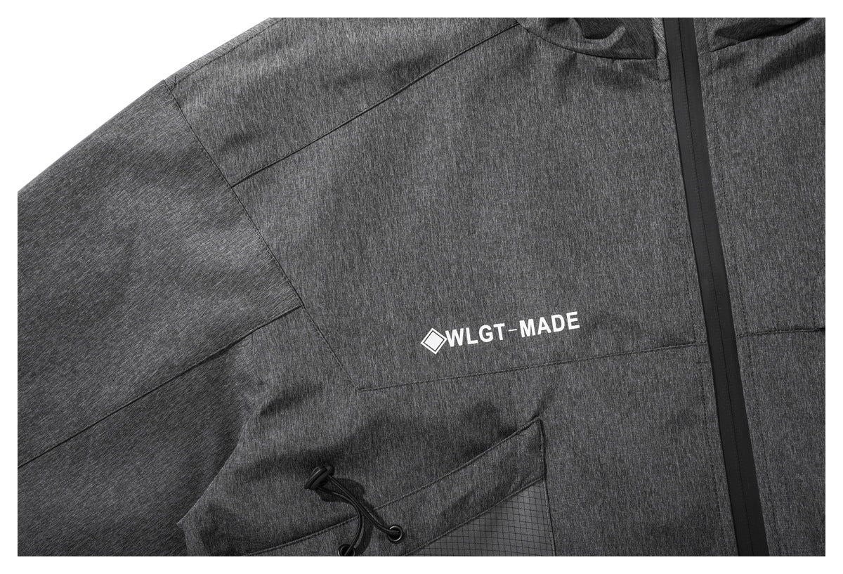 Close-up of a charcoal heather jacket chest with a small white WLG-MADE print and black front zipper.