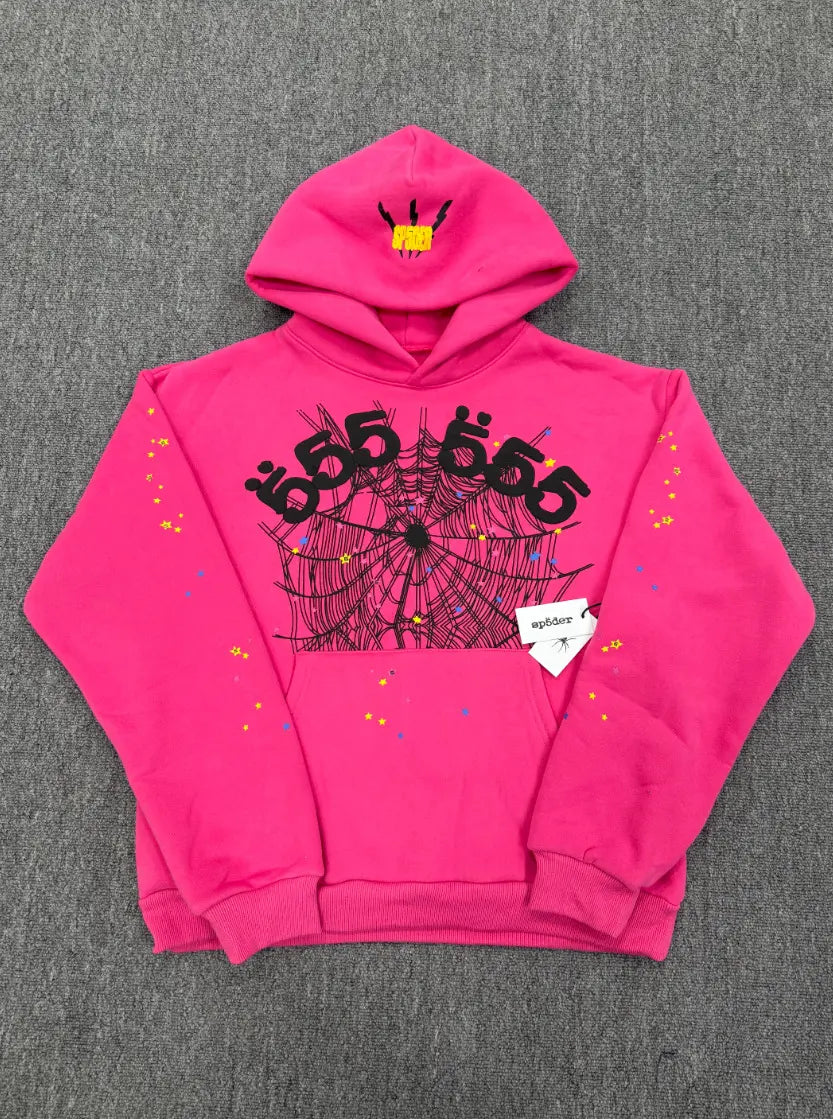 Hot pink Sp5der 555 pullover hoodie with black spider web graphic and multicolor star print details on sleeves