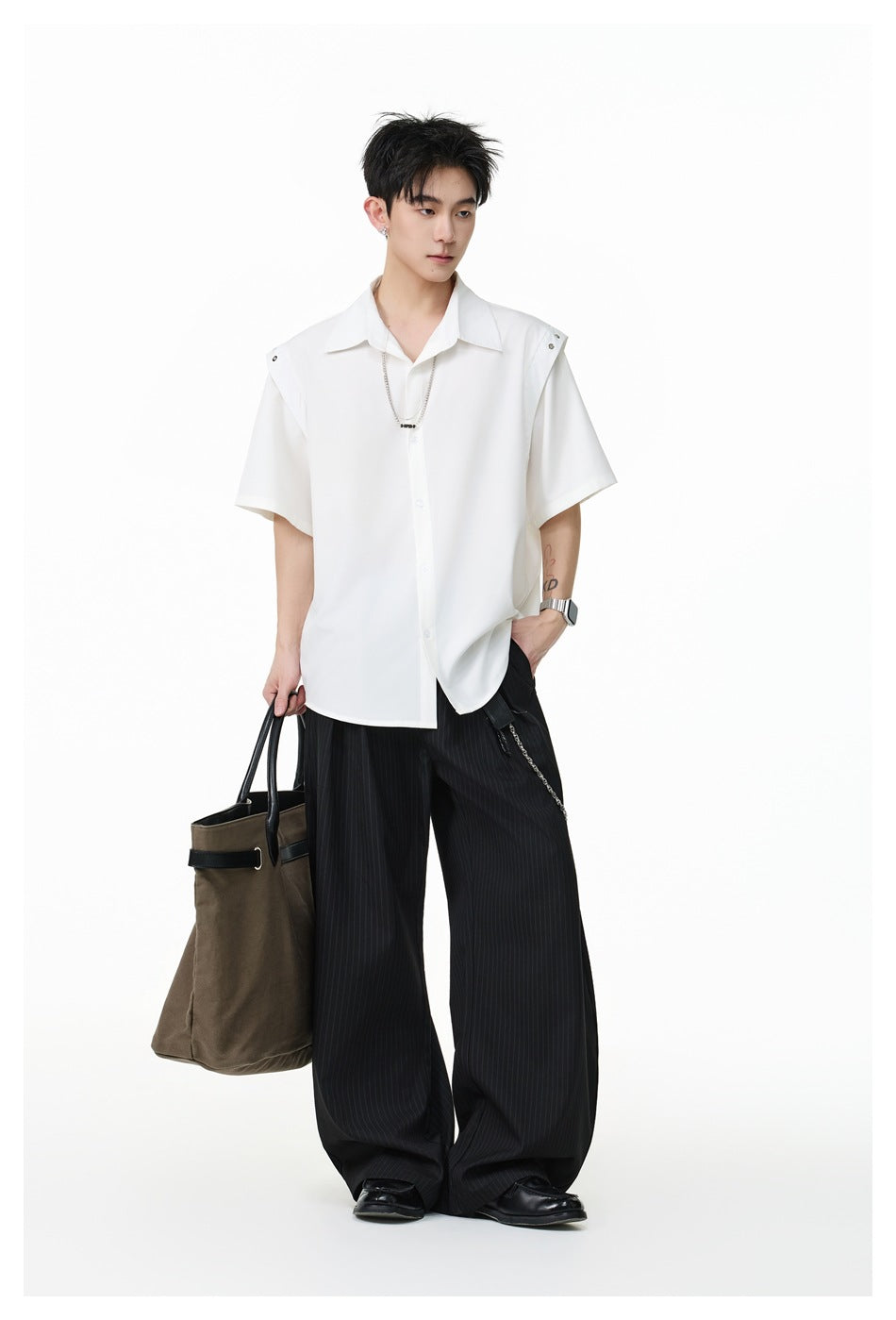 Full-length model wearing a white short-sleeve button-up shirt with wide black pinstripe trousers.