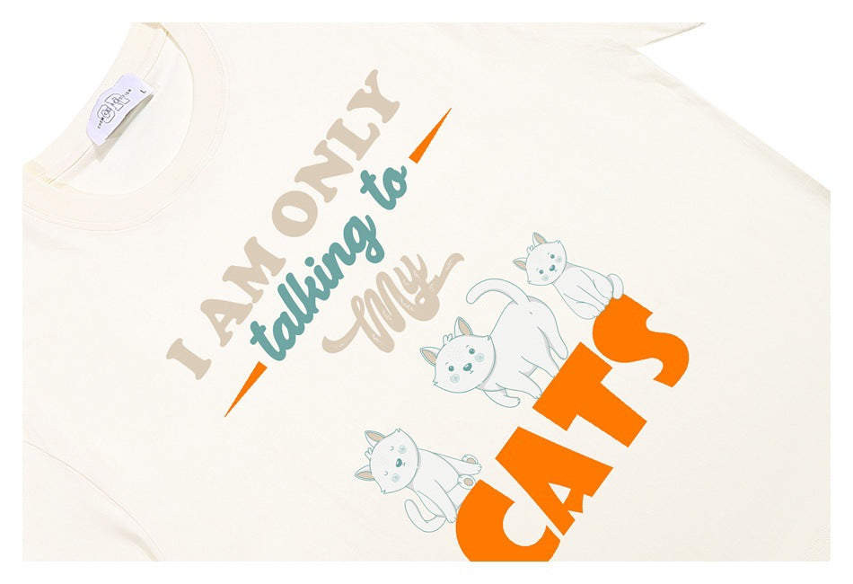 Off-white T-shirt graphic with playful lettering, orange accents, and three illustrated cats.