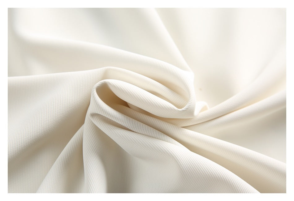 Close-up of cream fabric gathered to show its fine ribbed surface.