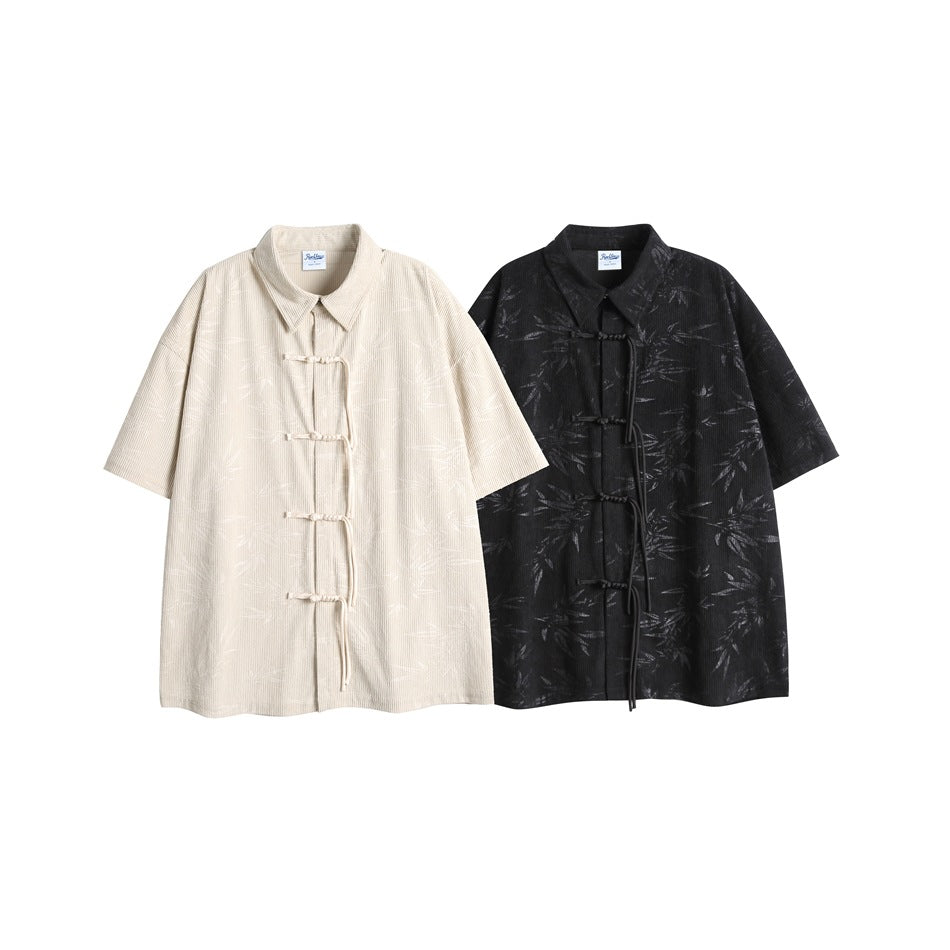 Two short-sleeve tie-front shirts shown side by side in cream and black, both with subtle leaf patterns.