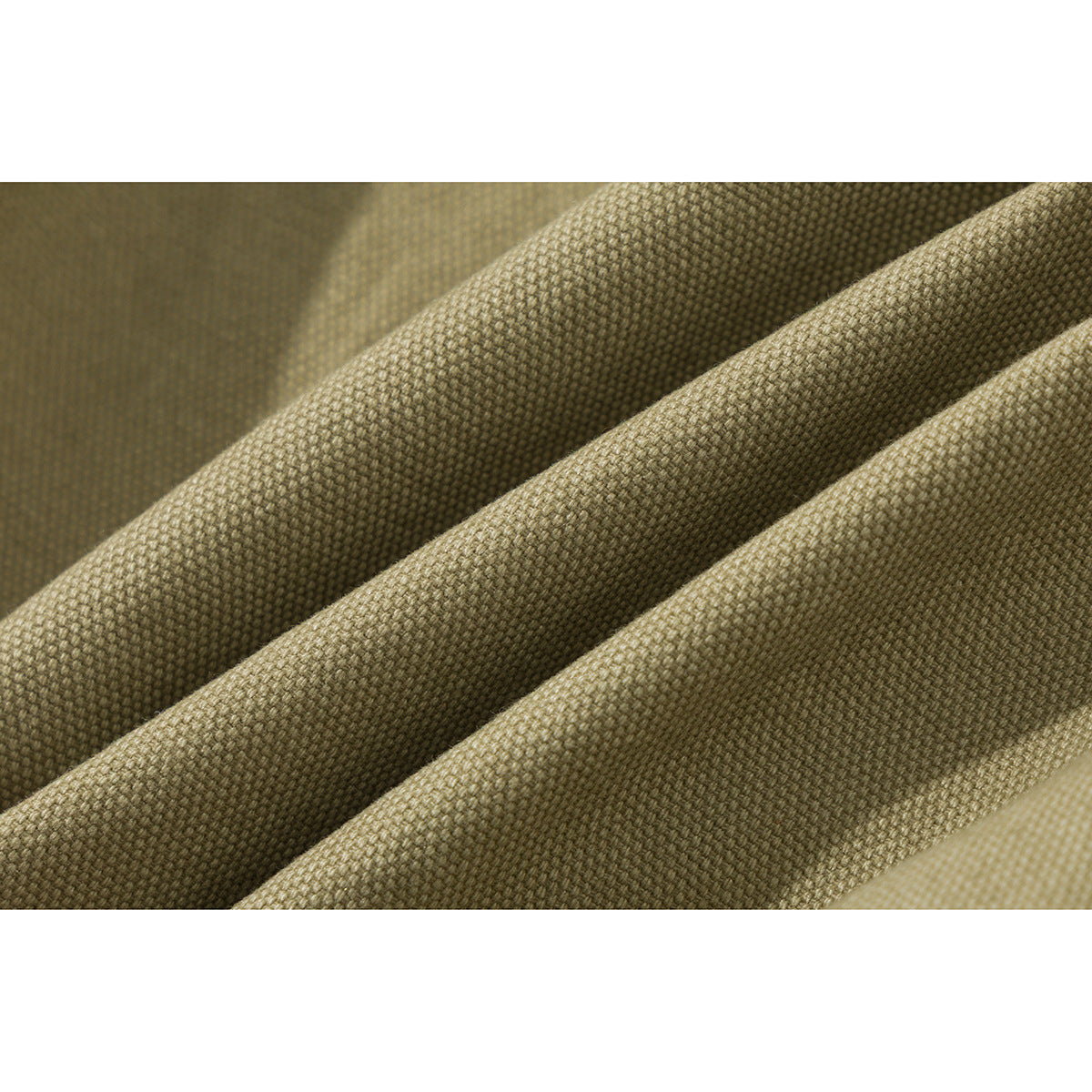 Macro view of khaki woven fabric gathered into diagonal folds.