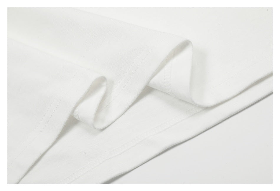 Close-up of white fabric with a curved folded edge and neat stitching.
